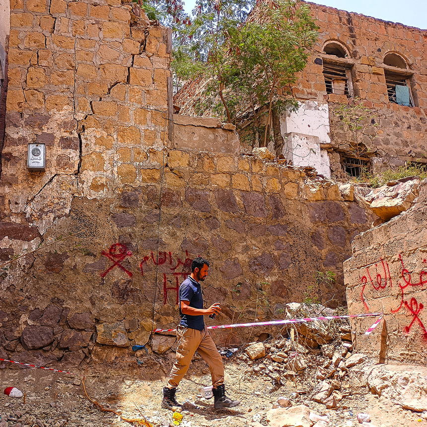 Staff member dealing with unexploded ordnance in Ta'iz