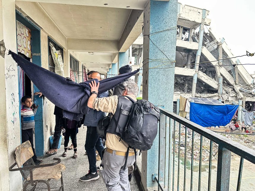 HALO team conduct a hazard assessment in a makeshift shelter in Gaza, surrounded by destroyed buildings