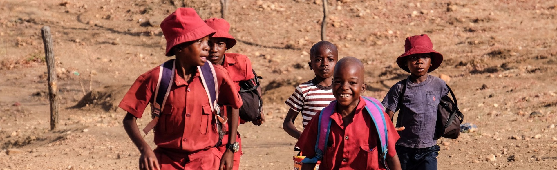 School kids walk through a rural area in Zimbabwe