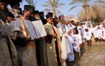Clergy lead a solemn procession during the epiphany service at the Baptism site, dressed in traditional robes.