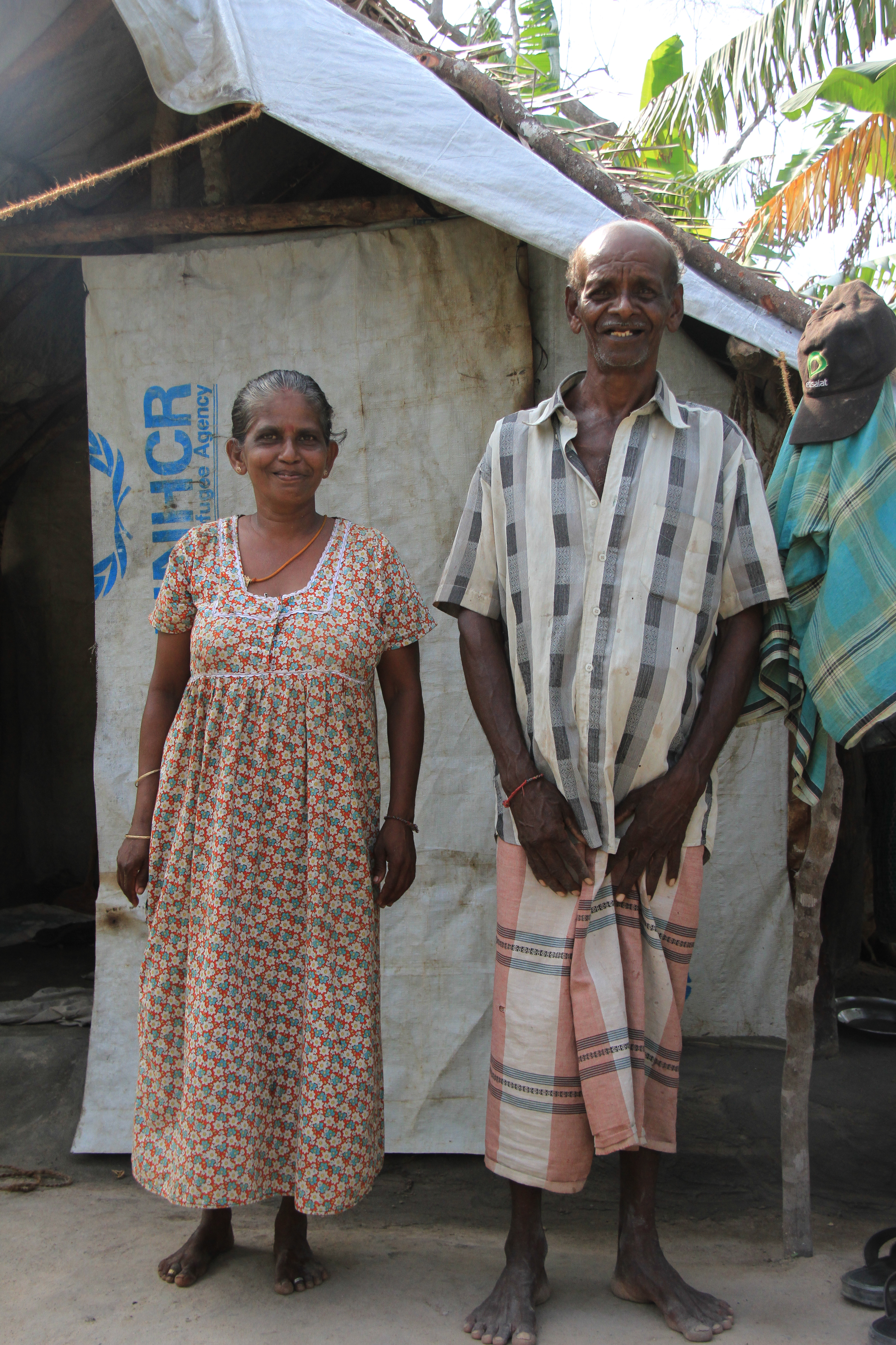 Mr Muthiya Nadason and his wife in front of their home