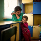 Two small children and an adult in a school in Nagorno Karabakh