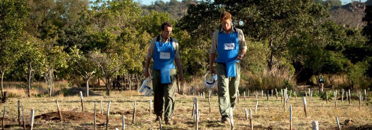 Prince Harry and HALO Trust CEO, James Cowan wear PPE and walk through a cleared minefield