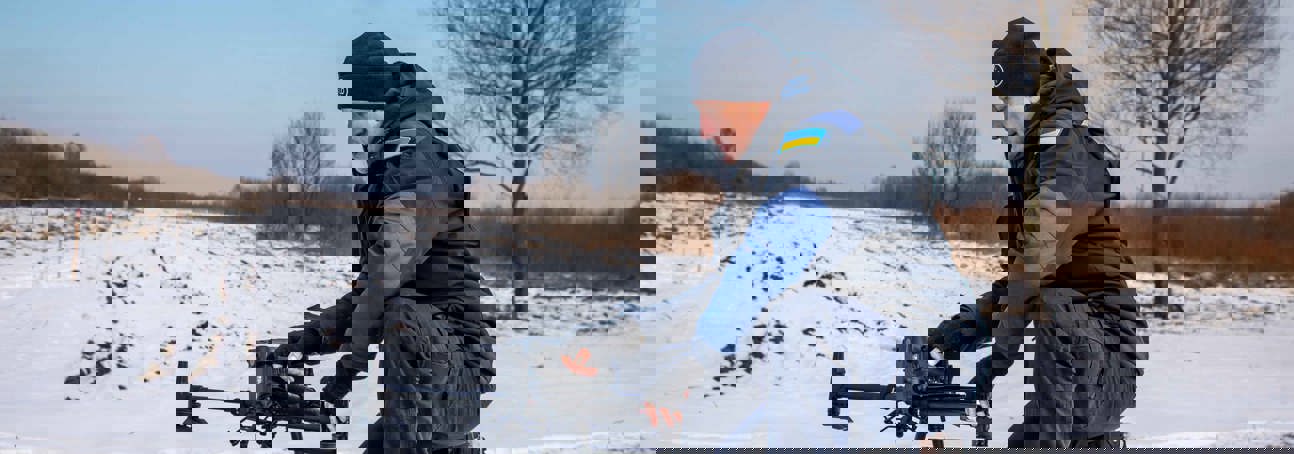 HALO team member setting up a drone in the snow