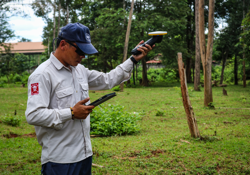 HALO staff member working with Trimble mapping equipment in Laos
