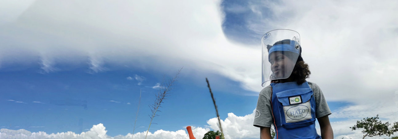 BP funded deminer carefully excavates a mine in a rural minefield in Angola