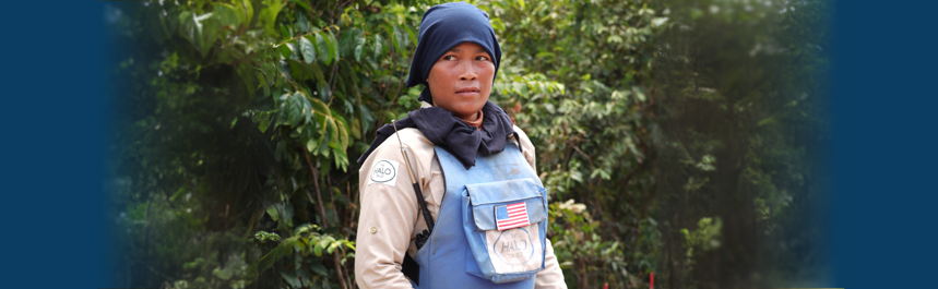 Ly Sreyneang wears PPE whilst looking out to the right