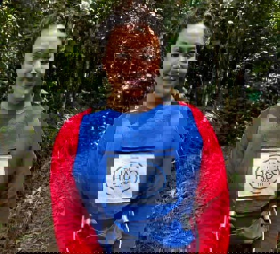 Woman in a red top, wearing a blue HALO vest