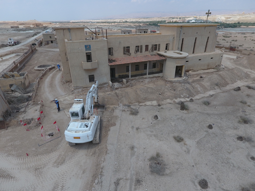 A digger sits outside a building around the baptism site of Jesus Christ