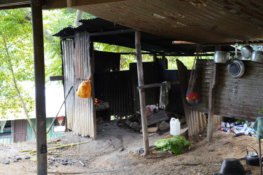 A shack made from metal sheets with kitchen and home objects inside
