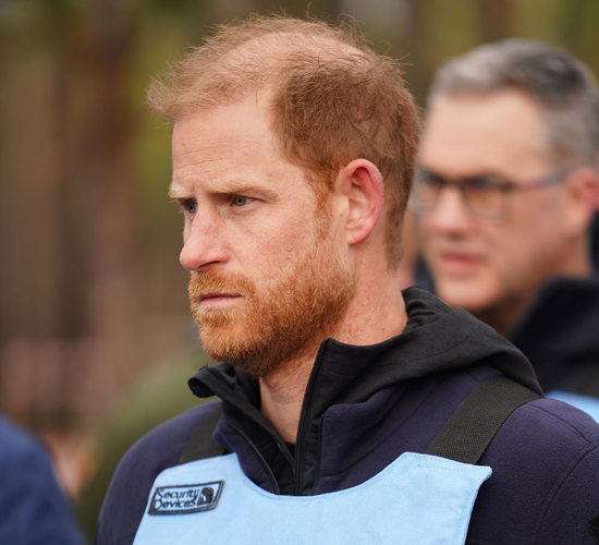 Vertical headshot of Prince Harry, who wears a HALO vest with the Ukrainian flag.