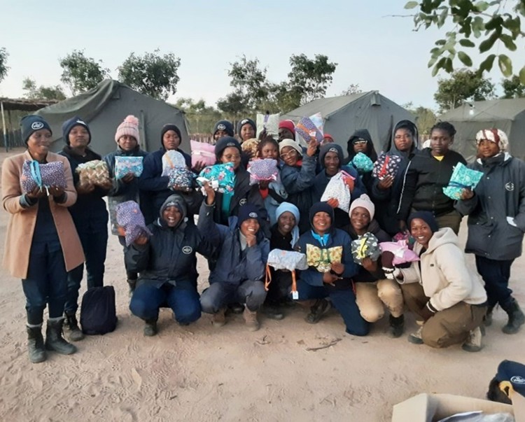A large group of women in Angola pose with their personal hygiene kits